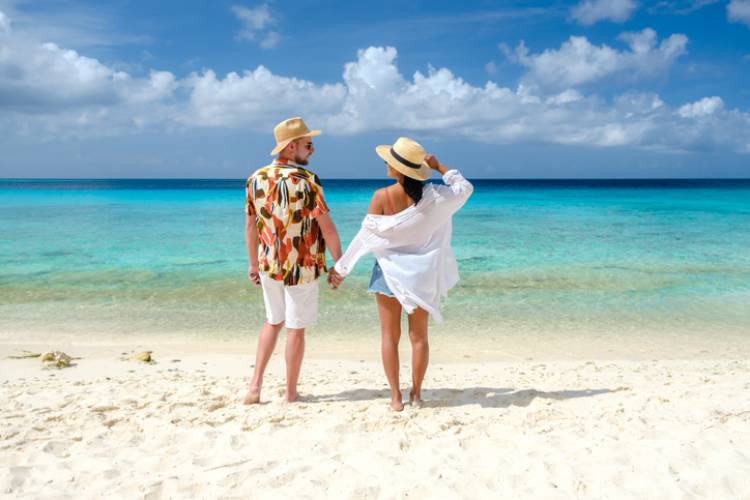 couple holding hands on beach in cape san blas